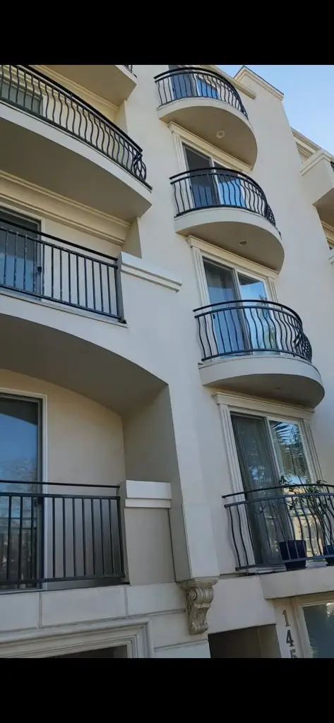 Older Los Angeles buildings with wrought iron balcony railings showing common safety concerns