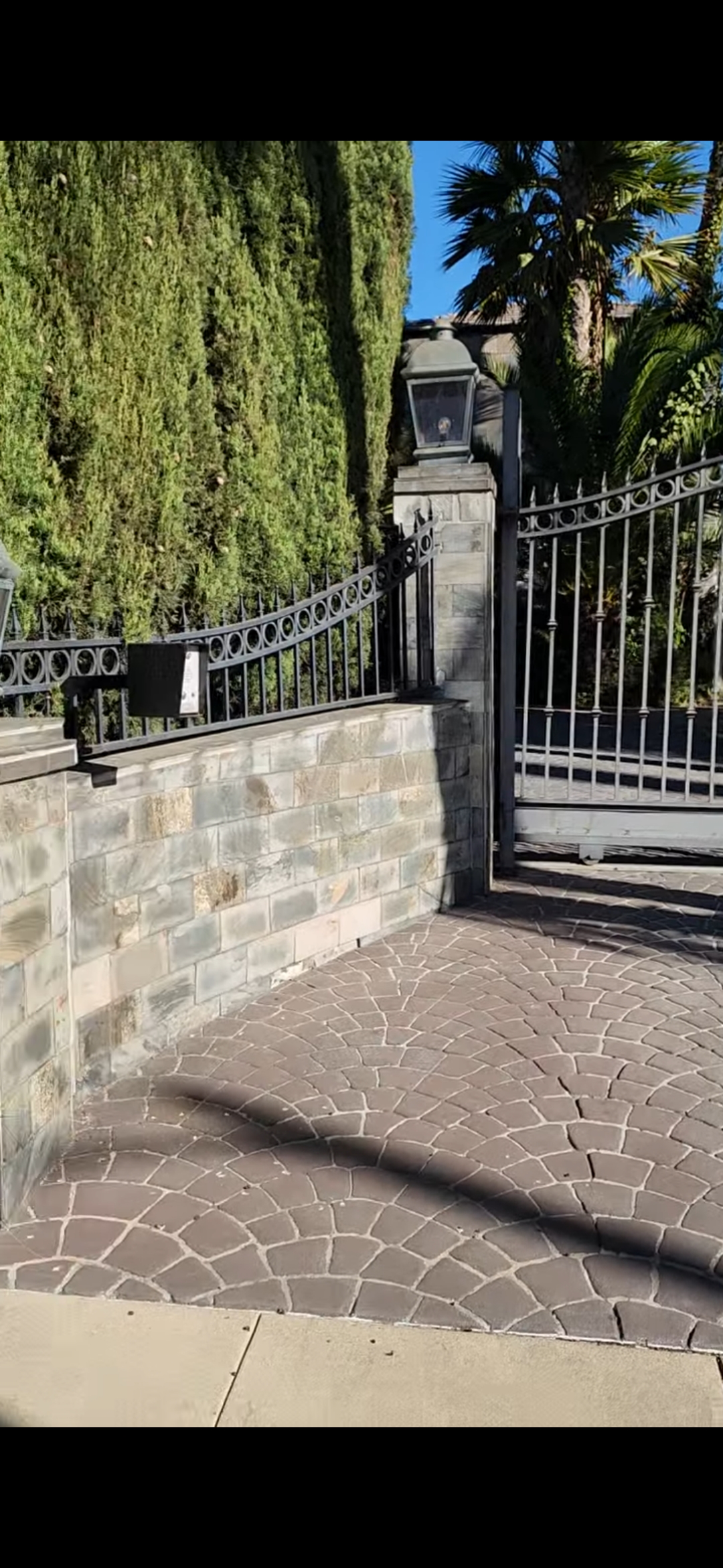Estate iron gate with stone wall Los Angeles